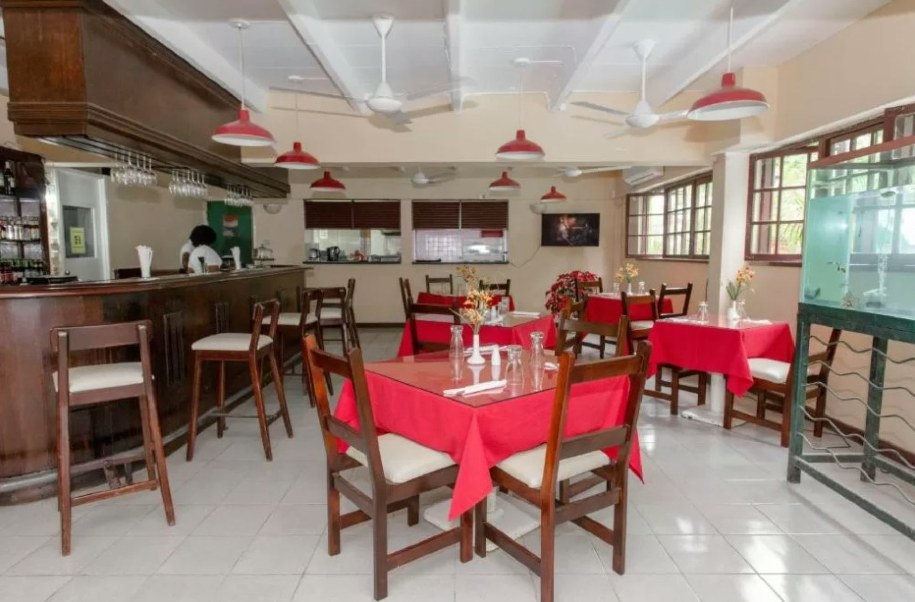 The restaurant at Pineapple Court with red tablecloths